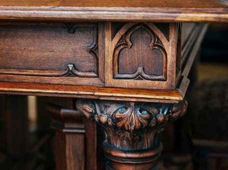 Close up of antique wooden table details, one of the many historic items that can be recovered through salvage