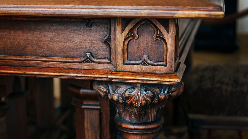 Close up of antique wooden table details, one of the many historic items that can be recovered through salvage