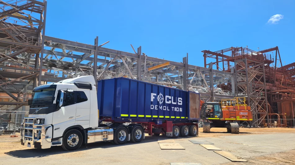 The focus demolition truck in front of the scaffolding of the Worsley Mine Site where a redundant Enhance Sands structure is being demolished.