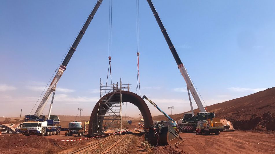 Cranes dismantling a rail tunnel bridge in an operating live mine site as part of the Mac/South Flank Area C Demolition.