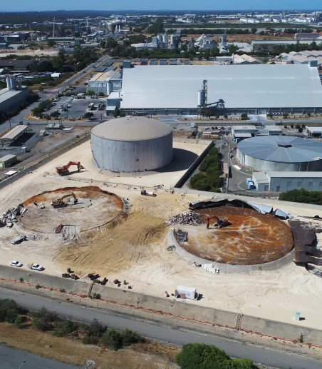 Far wide shot of the strategic demolition of the steel oil tanks on the live Kwinana Synergy site showing two tanks demolished.