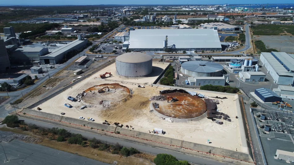 Far wide shot of the strategic demolition of the steel oil tanks on the live Kwinana Synergy site showing two tanks demolished.