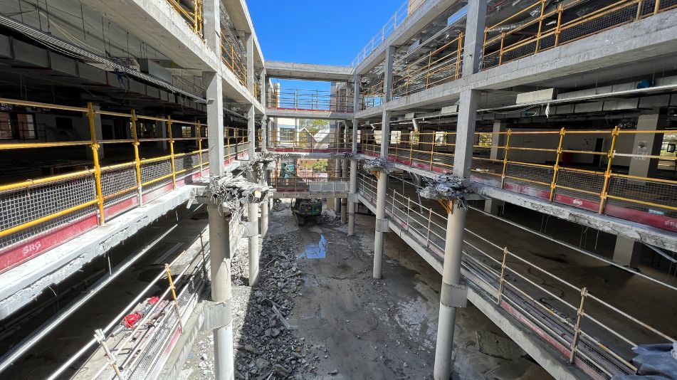 Wide shot of the demolition at Midland Square showing demolition across three floors with concrete rubble and dust.