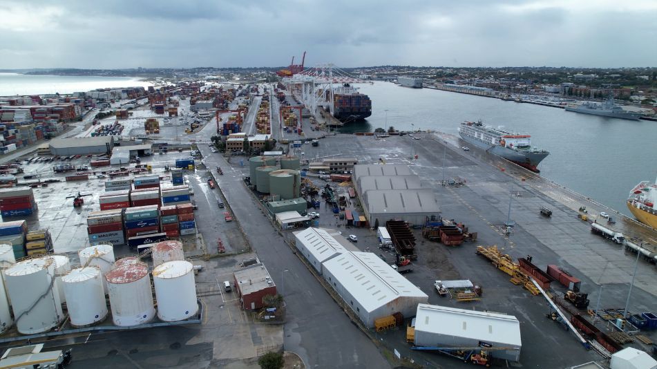 A far wide shot of the Sami Bitumen Plant in North Fremantle located next to the water with a port nearby.