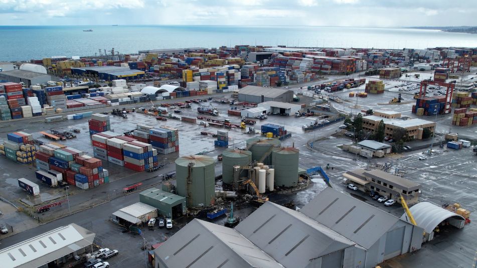 A far wide shot of the Sami Bitumen Plant in North Fremantle showing the surrounding shipping crates and buildings.