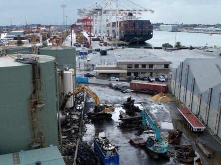 Wide shot of an excavator at work at the Sami Bitumen Plant in North Fremantle demolishing an aging tank as part of Focus Demolition.